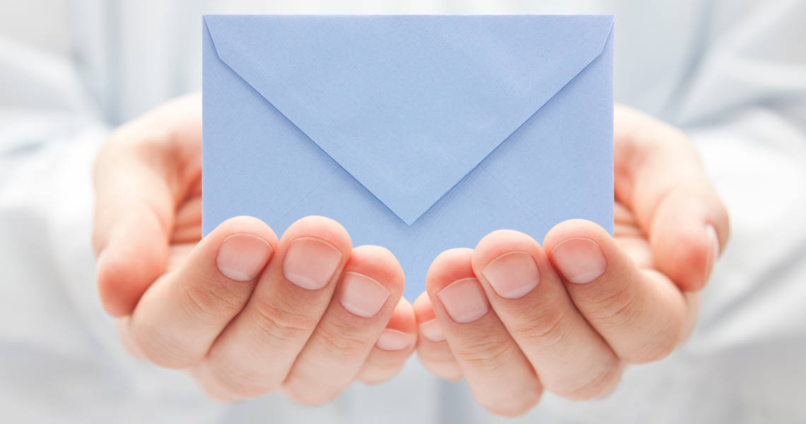 Blue envelope in hands