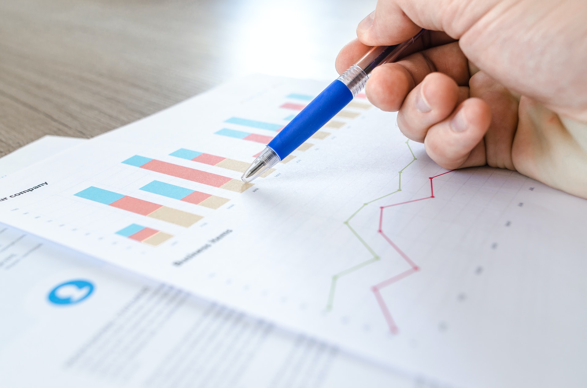 Surveyor reviewing property survey data and inspection findings on a report document
